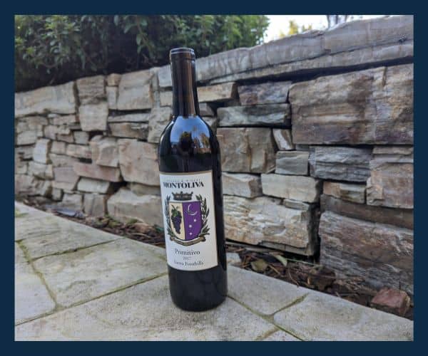 Bottle of Primitivo 2017 from Montoliva Winery in a natural setting