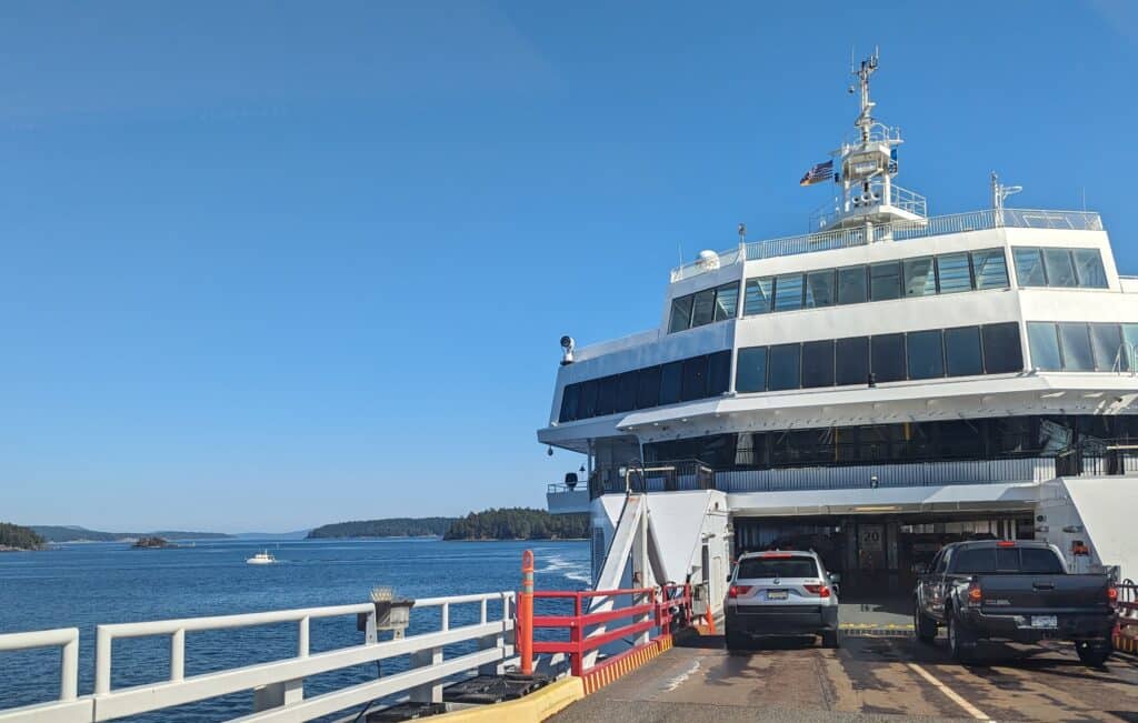 ferry with cars driving on to it